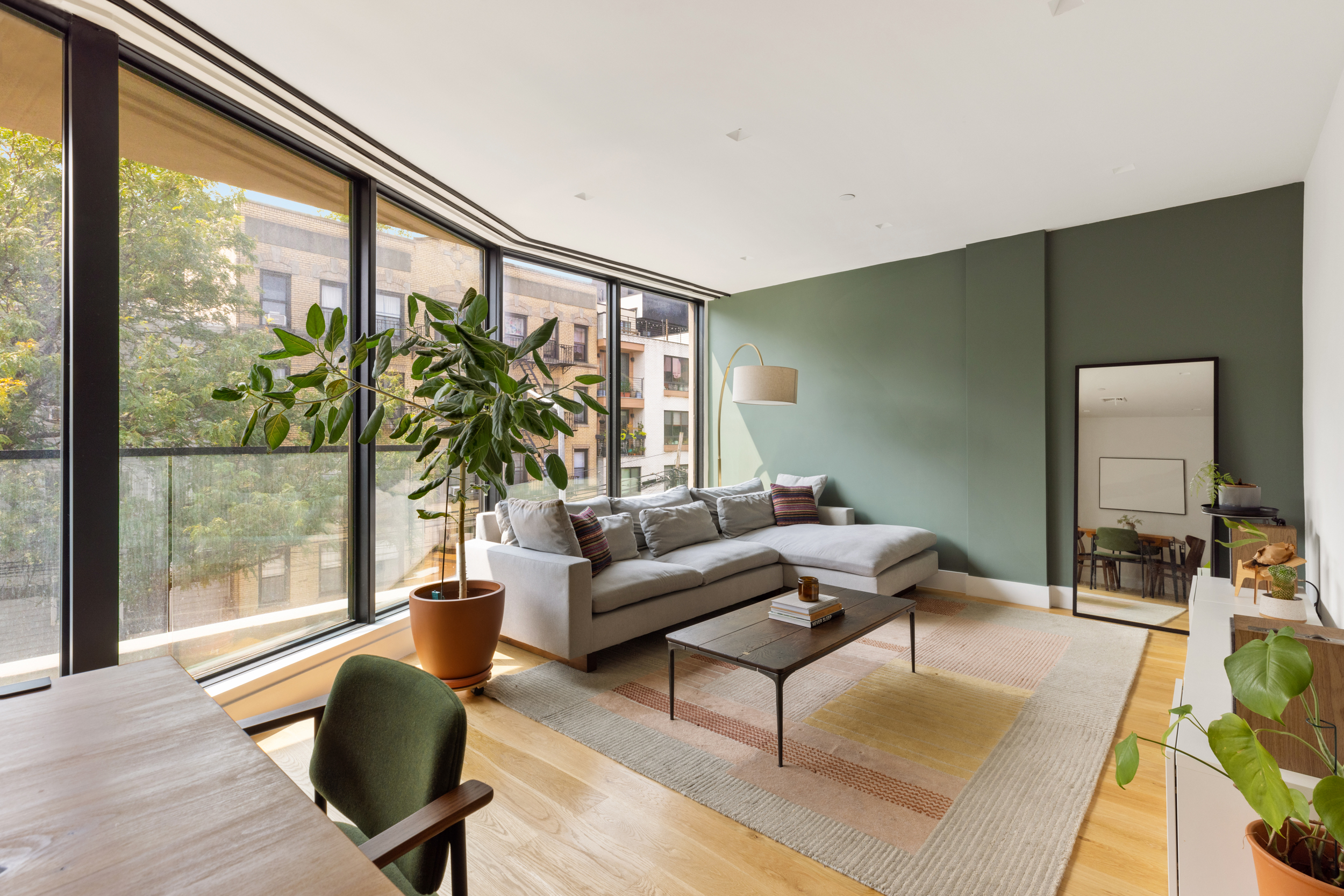 205 Freeman Street, Unit 3 Brooklyn, NY 11222 - Photo 2 of 9 a living room with furniture and a large window with balcony view