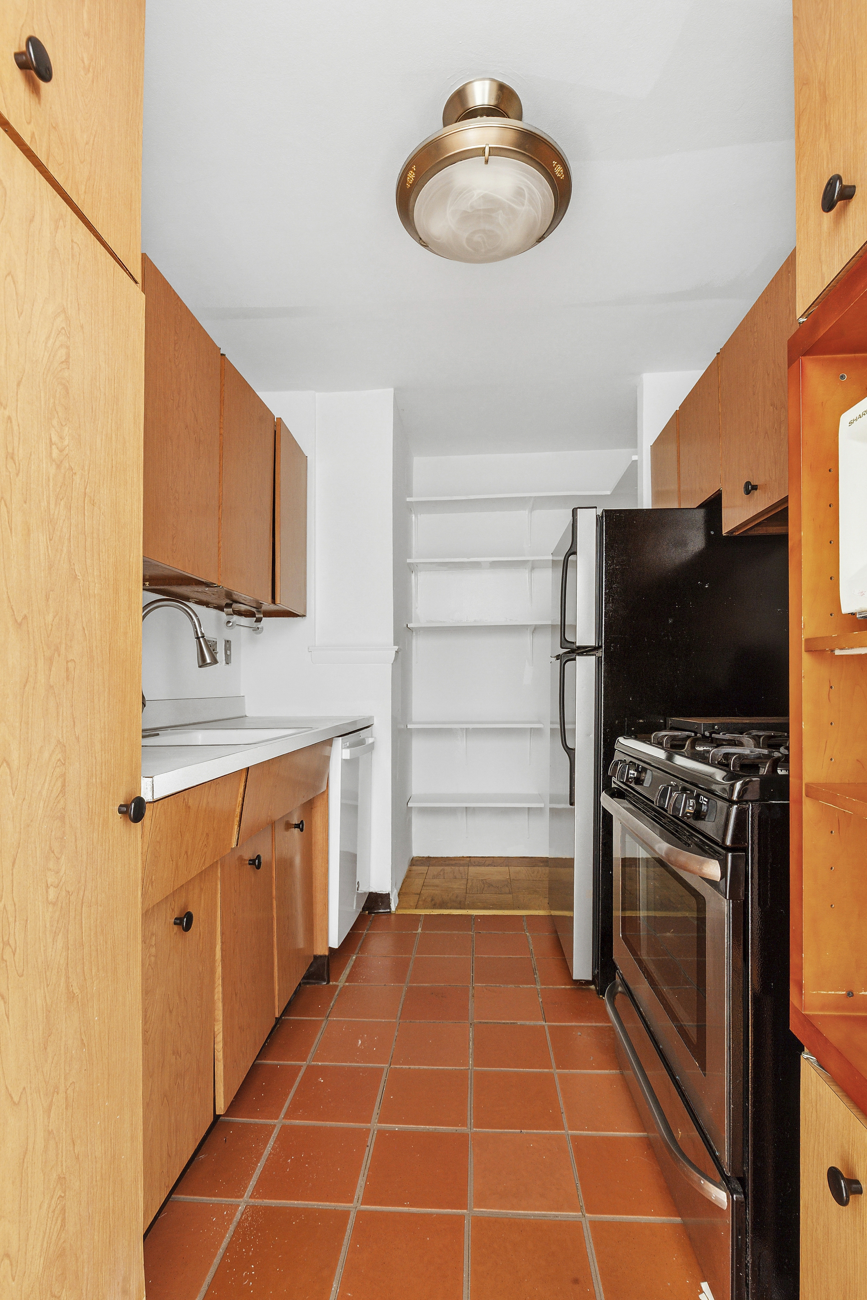 201 East 36th Street, Unit 5D Manhattan, NY 10016 - Photo 6 of 9 a kitchen with stainless steel appliances a stove and a microwave
