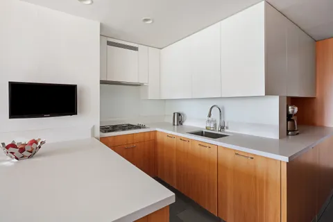 a kitchen with stainless steel appliances granite countertop a sink and a microwave