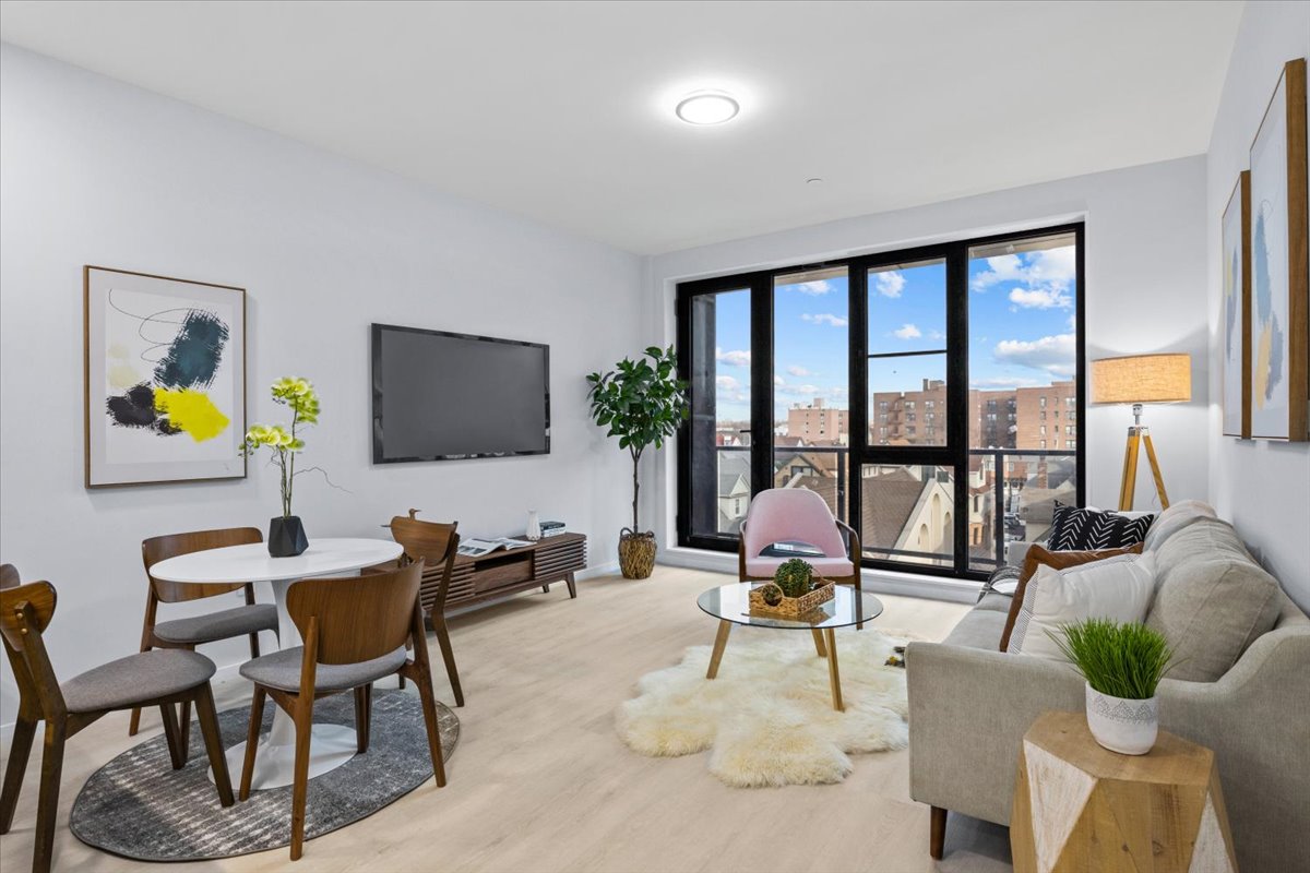 2654 East 18th Street, Unit 5D Brooklyn, NY 11235 - Photo 1 of 10 a living room with furniture and a flat screen tv