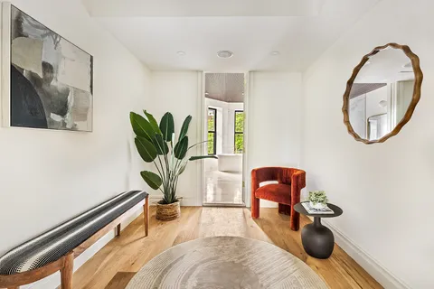 a living room with furniture and a potted plant