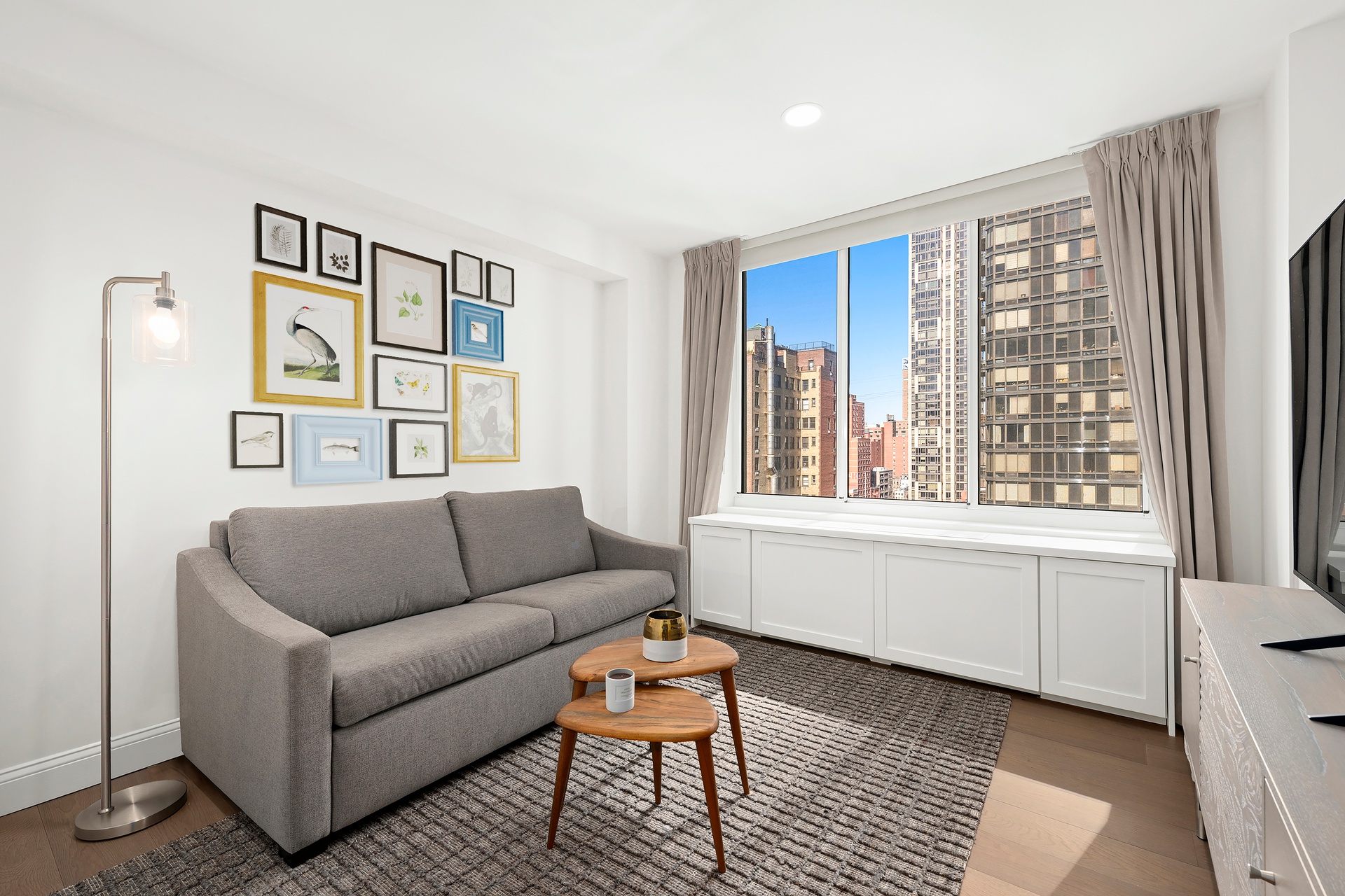 420 East 58th Street, Unit 14B Manhattan, NY 10022 - Photo 7 of 10 a living room with furniture and a window