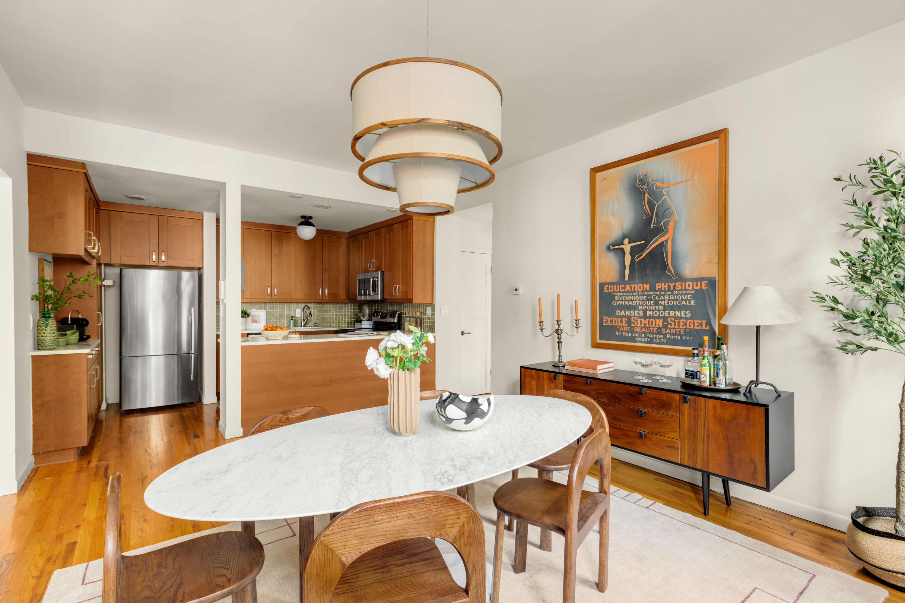 238 Clinton Street, Unit DE Brooklyn, NY 11201 - Photo 6 of 19 a kitchen with stainless steel appliances granite countertop a dining table chairs and a refrigerator