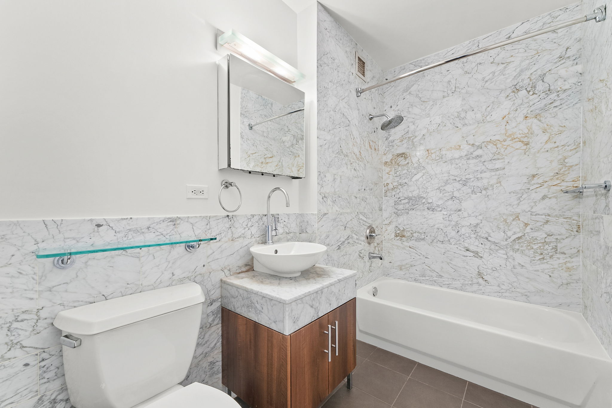 1 Wall Street Court, Unit 1405 Manhattan, NY 10005 - Photo 13 of 19 a bathroom with a sink toilet and shower