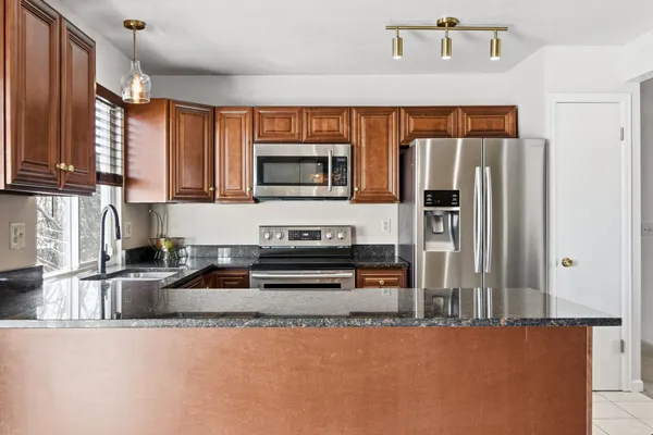 a bedroom with a bed a flat screen tv and a window