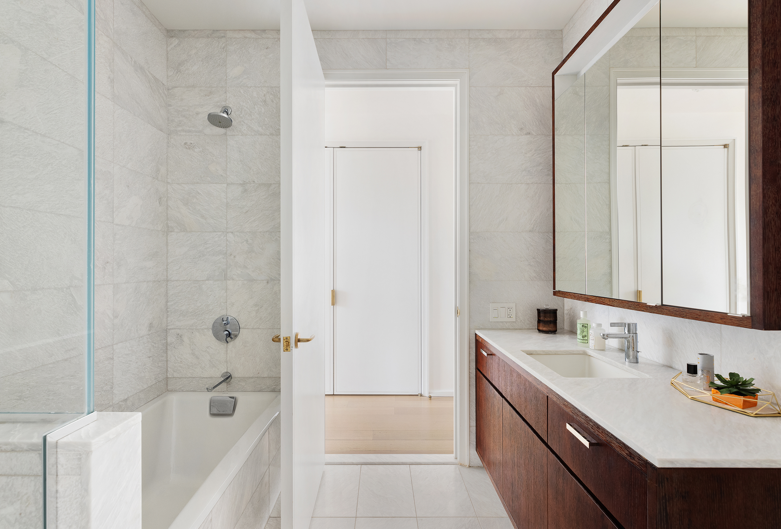 505 West 19th Street, Unit PH1 Manhattan, NY 10011 - Photo 22 of 26 a bathroom with a tub sink and mirror