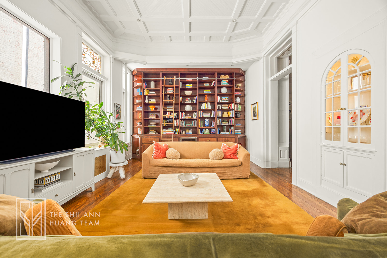 a living room with a large window and a flat screen tv