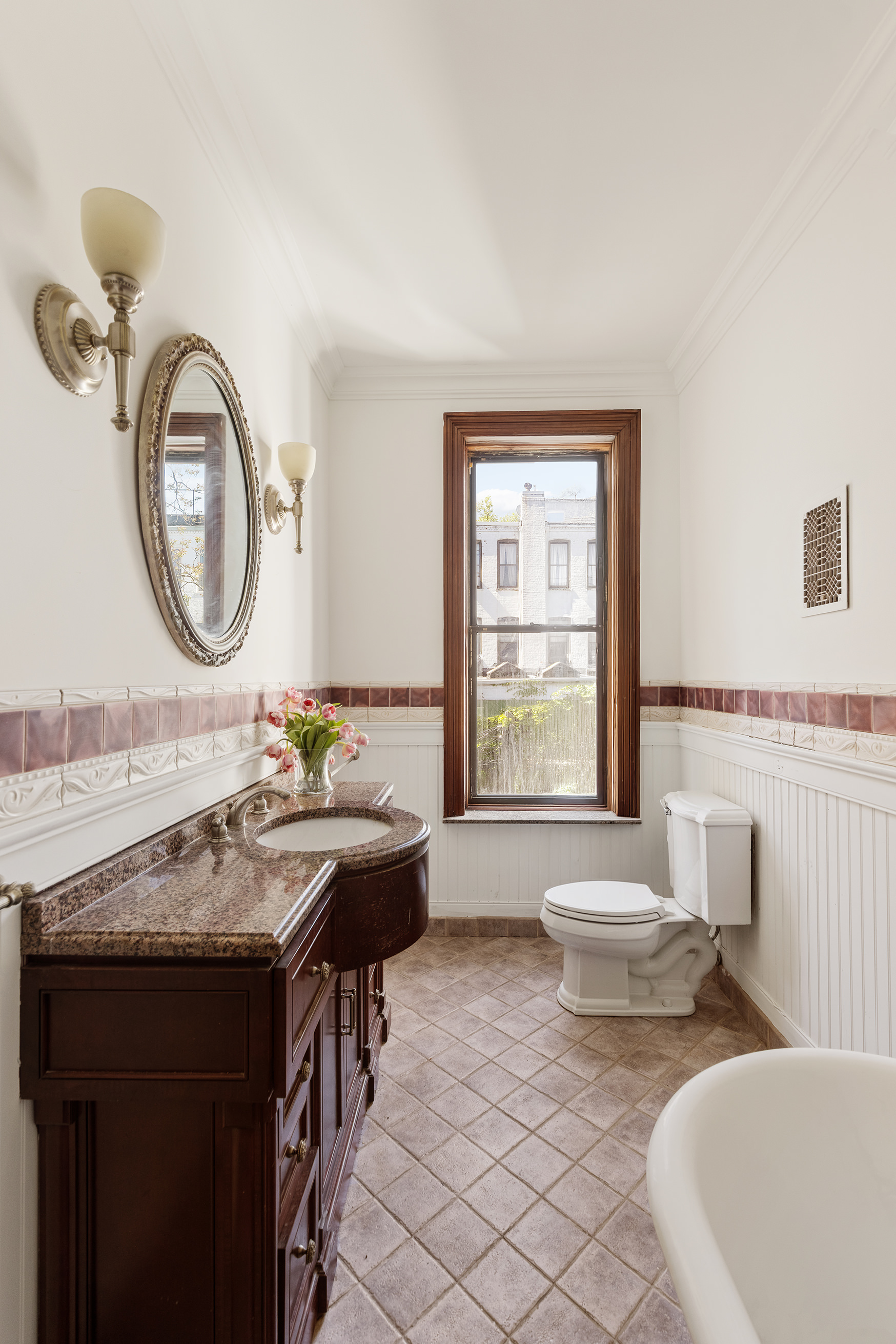 608 2nd Street Brooklyn, NY 11215 - Photo 26 of 34 a bathroom with a granite countertop sink and a mirror