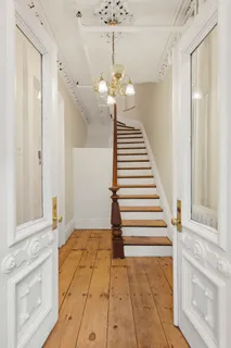 a view of entryway and hall with wooden floor