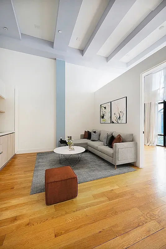 30 Starr Street, Unit 4B Brooklyn, NY 11221 - Photo 2 of 5 a living room with furniture and a flat screen tv