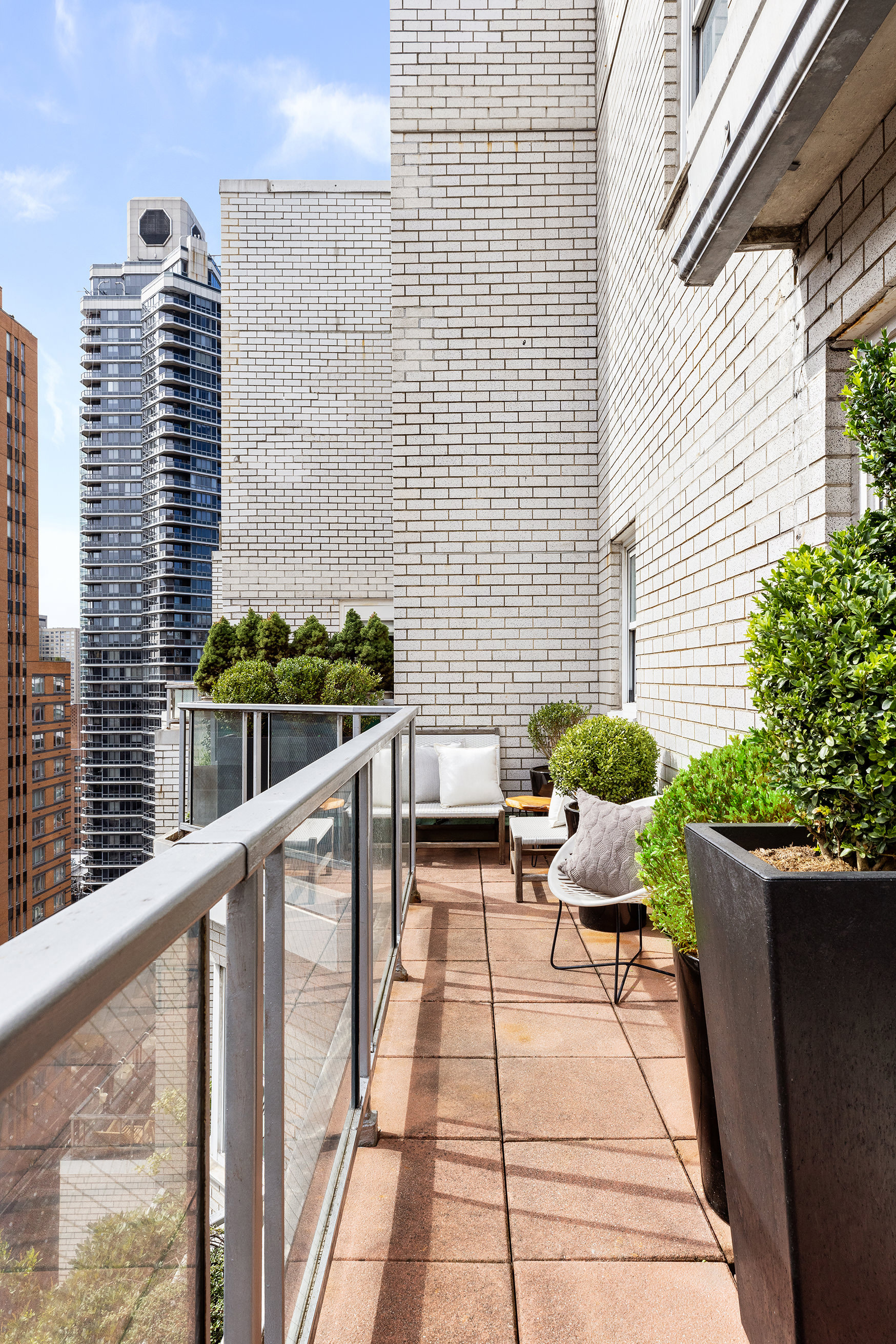 175 East 62nd Street, Unit PHA Manhattan, NY 10065 - Photo 3 of 18 a balcony with wooden floor and furniture