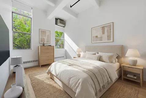 a bedroom with a bed and a couch