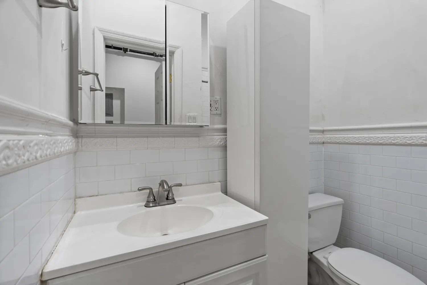 a bathroom with a sink a toilet and mirror