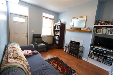 a living room with furniture and a fireplace