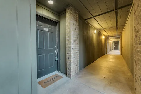 a view of kitchen with kitchen island wooden floor center island and stainless steel appliances