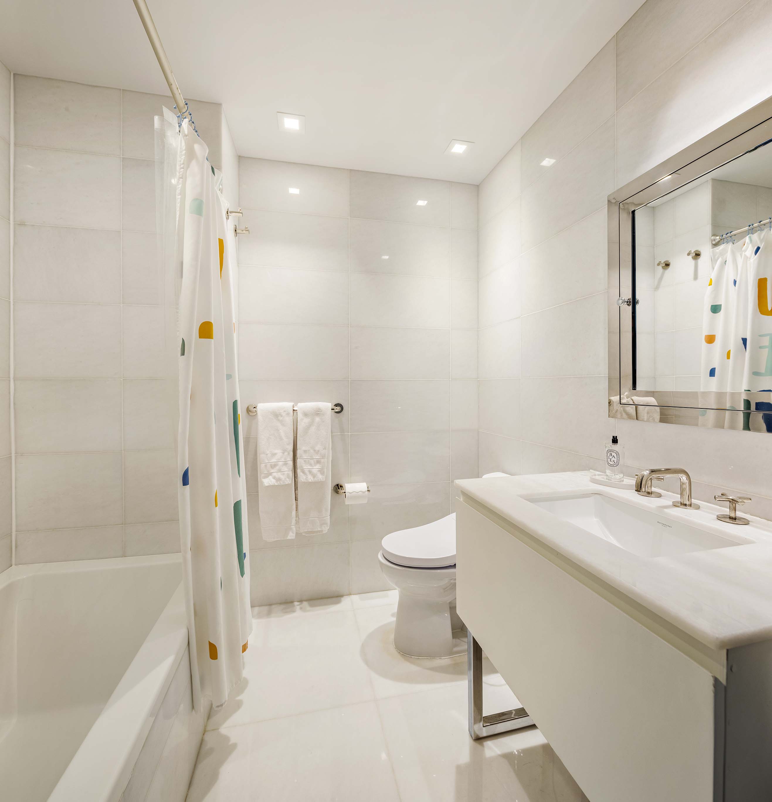 5 Franklin Place, Unit 14A Manhattan, NY 10013 - Photo 12 of 23 a bathroom with a sink a toilet and shower