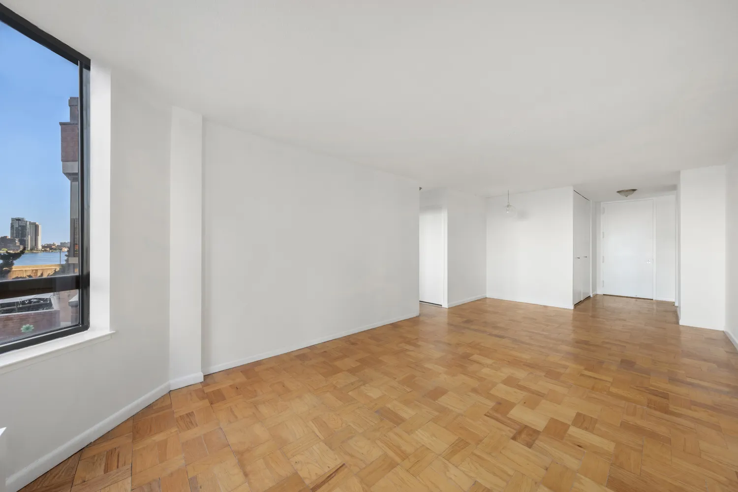 a view of an empty room and closet area