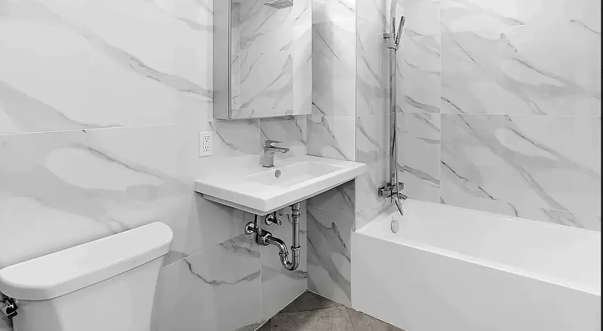 319 Broadway, Unit PHA Brooklyn, NY 11211 - Photo 5 of 6 a bathroom with a sink a toilet and bathtub