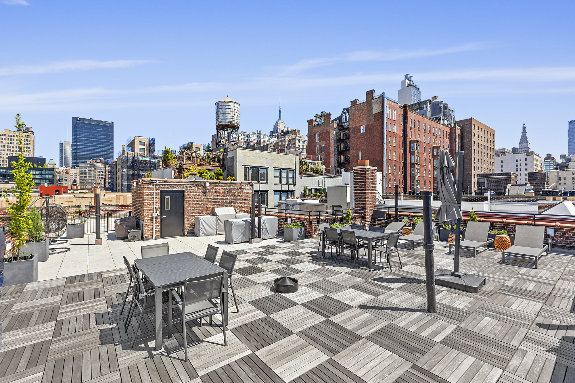261 West 22nd Street, Unit 12A14 Manhattan, NY 10011 - Photo 10 of 14 a outdoor space with lots of tables a chairs and a couch