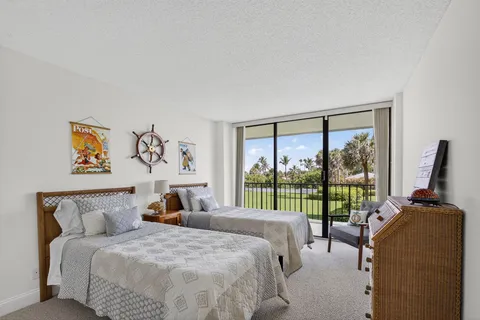 a view of a porch with furniture and a floor to ceiling window
