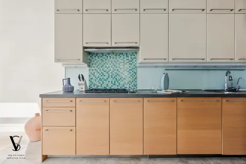 a kitchen with white cabinets and a sink