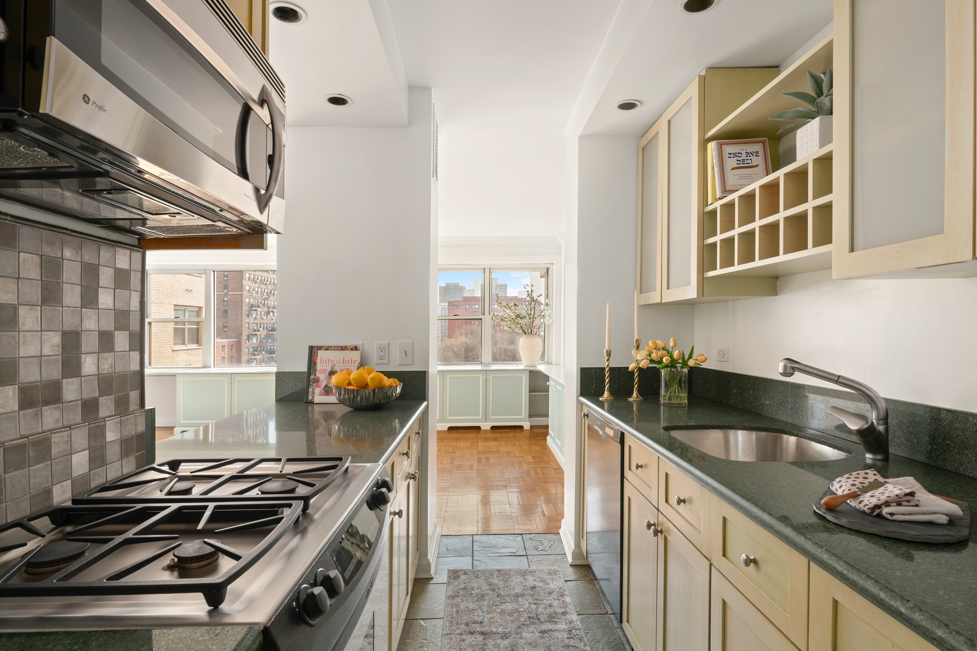 20 East 9th Street, Unit 11M Manhattan, NY 10003 - Photo 10 of 28 a kitchen with granite countertop a stove and a sink