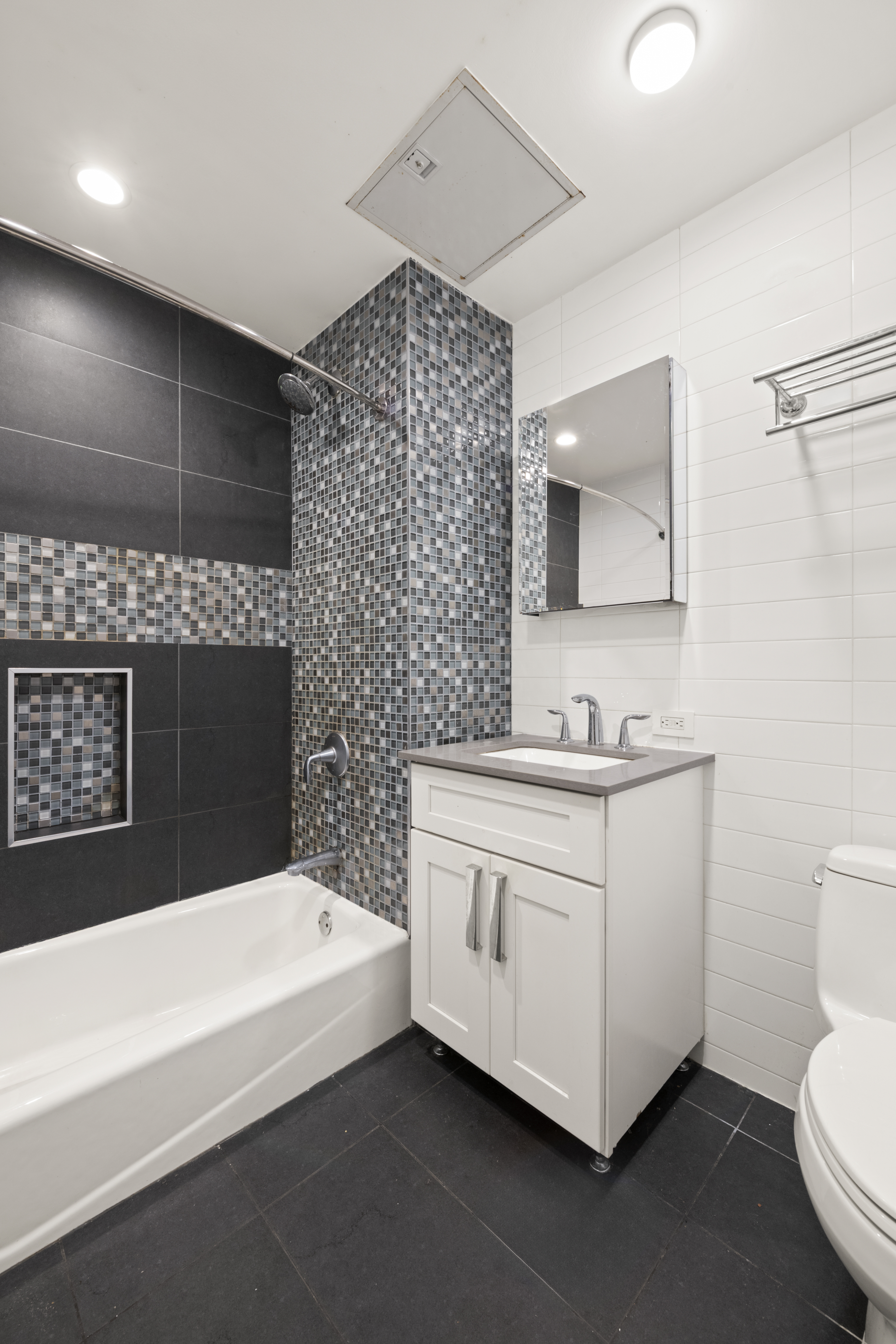 25 Lexington Avenue, Unit 103 Brooklyn, NY 11238 - Photo 7 of 15 a bathroom with a sink a toilet and mirror