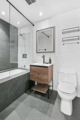 425 East 13th Street, Unit 2A Manhattan, NY 10009 - Photo 2 of 7 a bathroom with a toilet sink and mirror