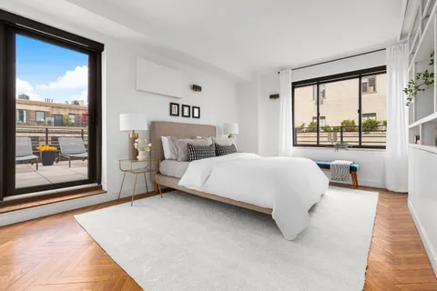 a bedroom with a large bed and a large window