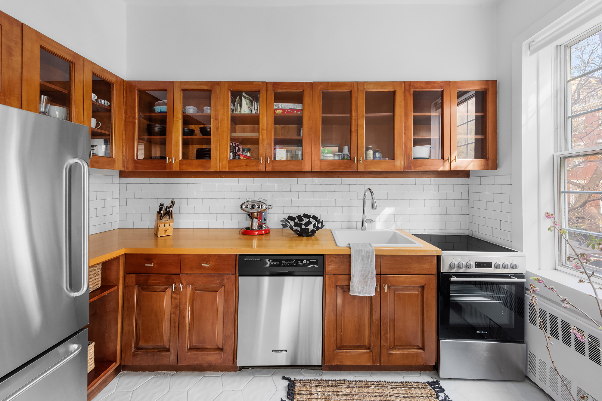 159 West 13th Street Manhattan, NY 10011 - Photo 15 of 36 a kitchen view of a kitchen with stainless steel appliances granite countertop a stove and a refrigerator
