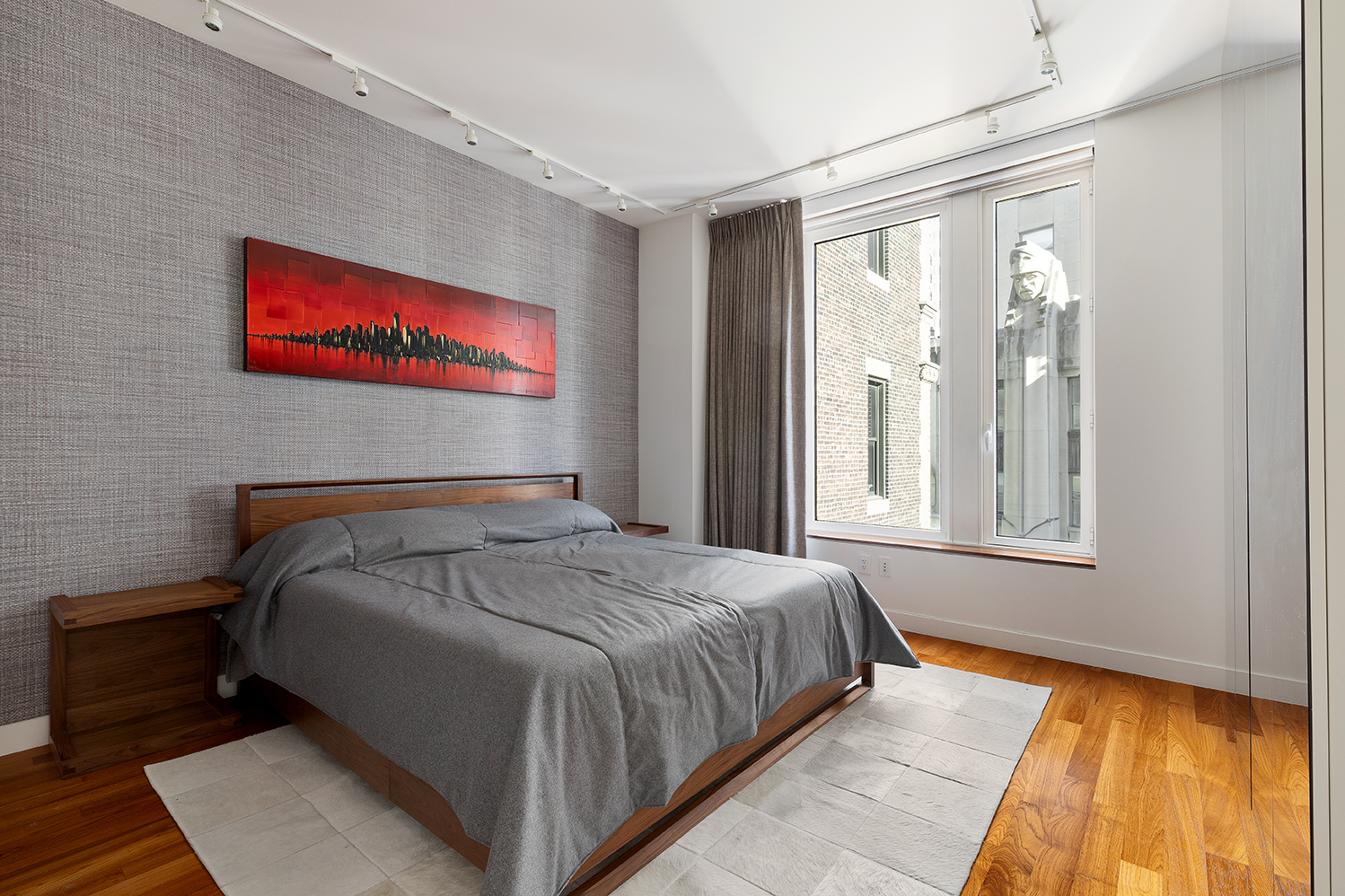 15 William Street, Unit 22H Manhattan, NY 10005 - Photo 5 of 20 a bed sitting in a bedroom next to a window