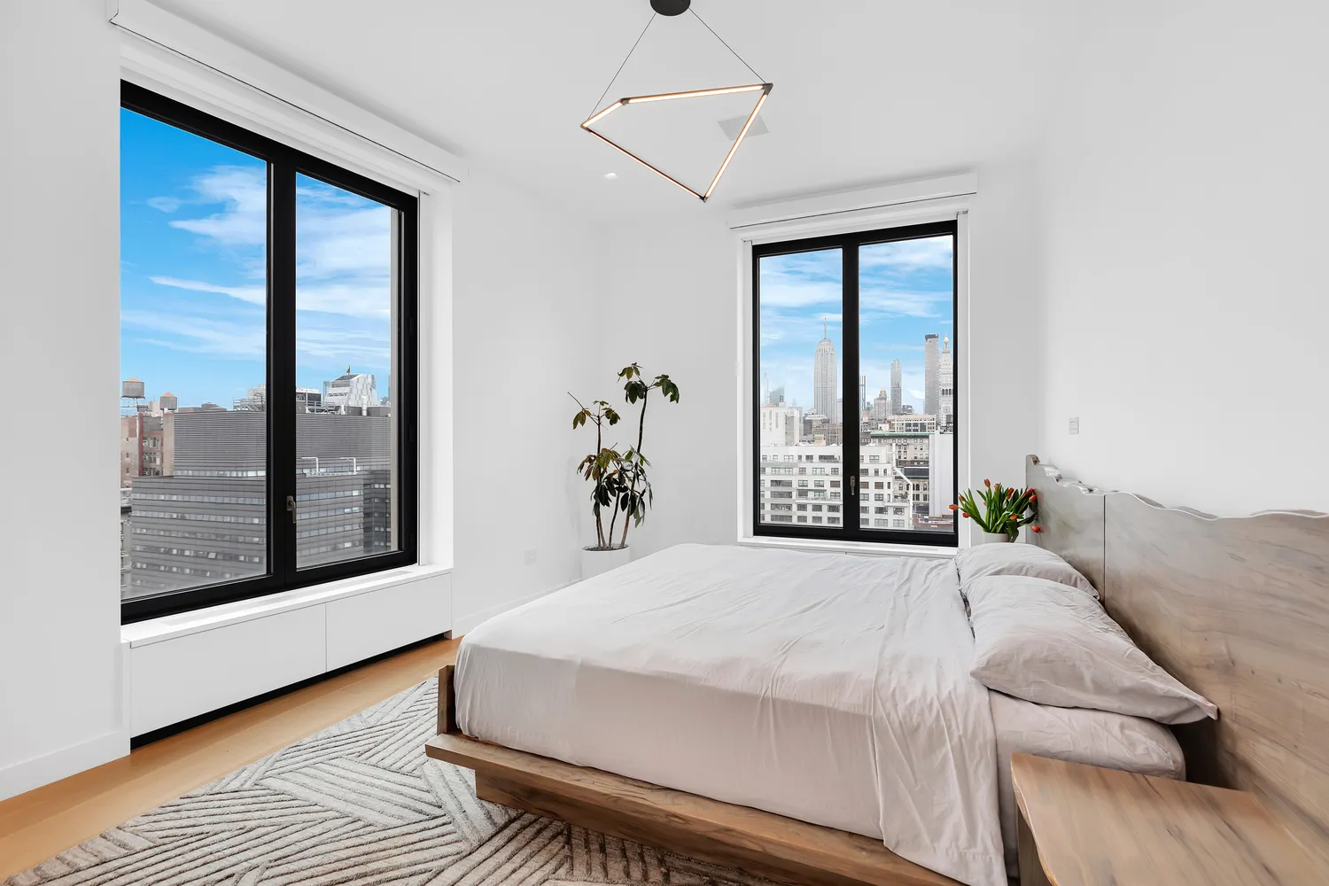 a bedroom with a large bed and a large window