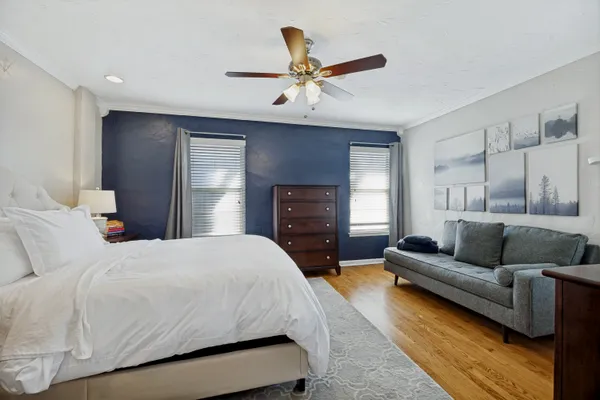 a bedroom with a bed couch and window