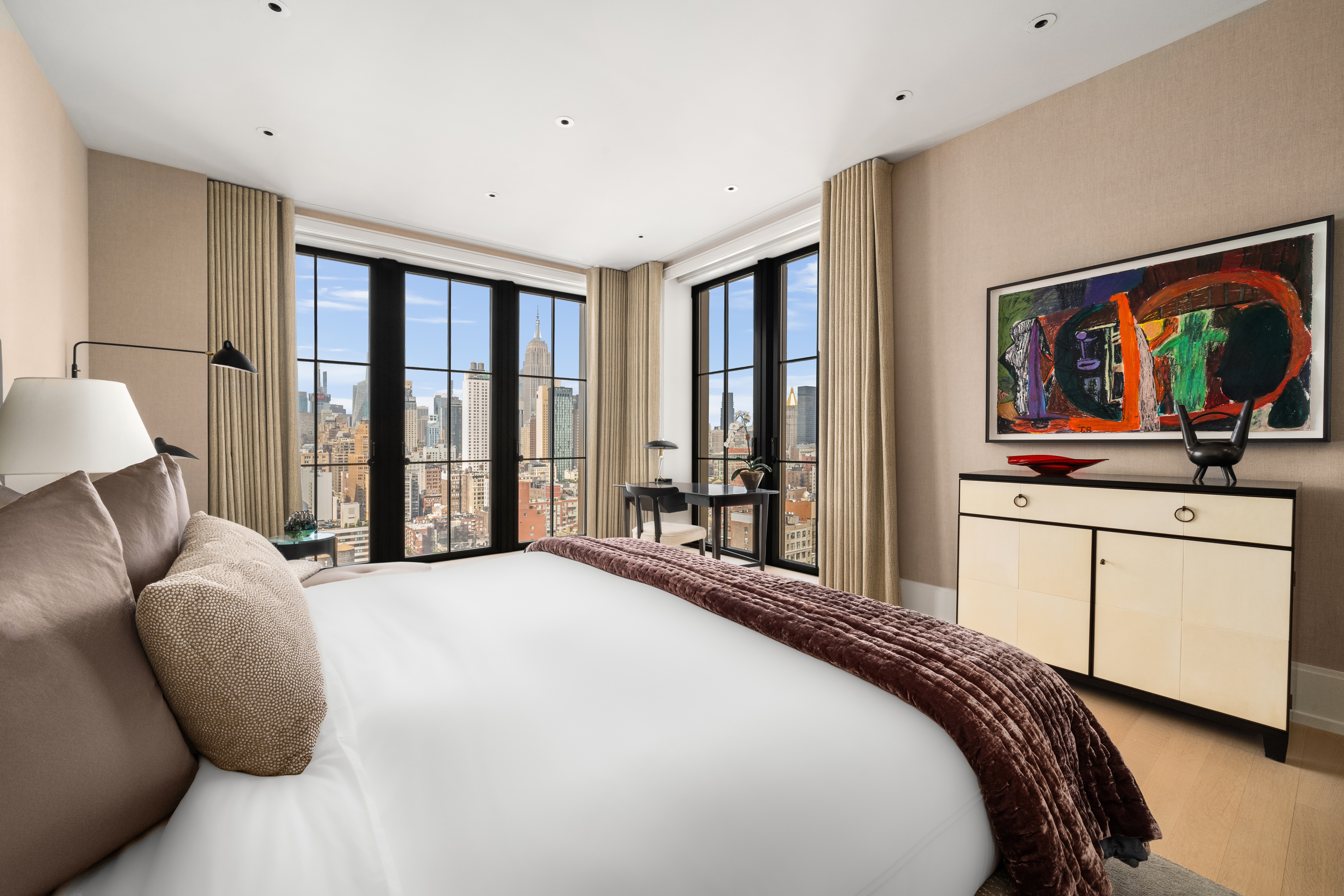 212 West 18th Street, Unit 19C Manhattan, NY 10011 - Photo 9 of 27 a bedroom with a bed painting on wall and a large window