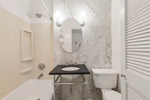 a bathroom with a sink toilet and shower