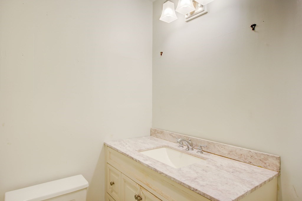 327 Commonwealth Avenue Boston, MA 02115 - Photo 21 of 26 a bathroom with a granite countertop sink and a mirror