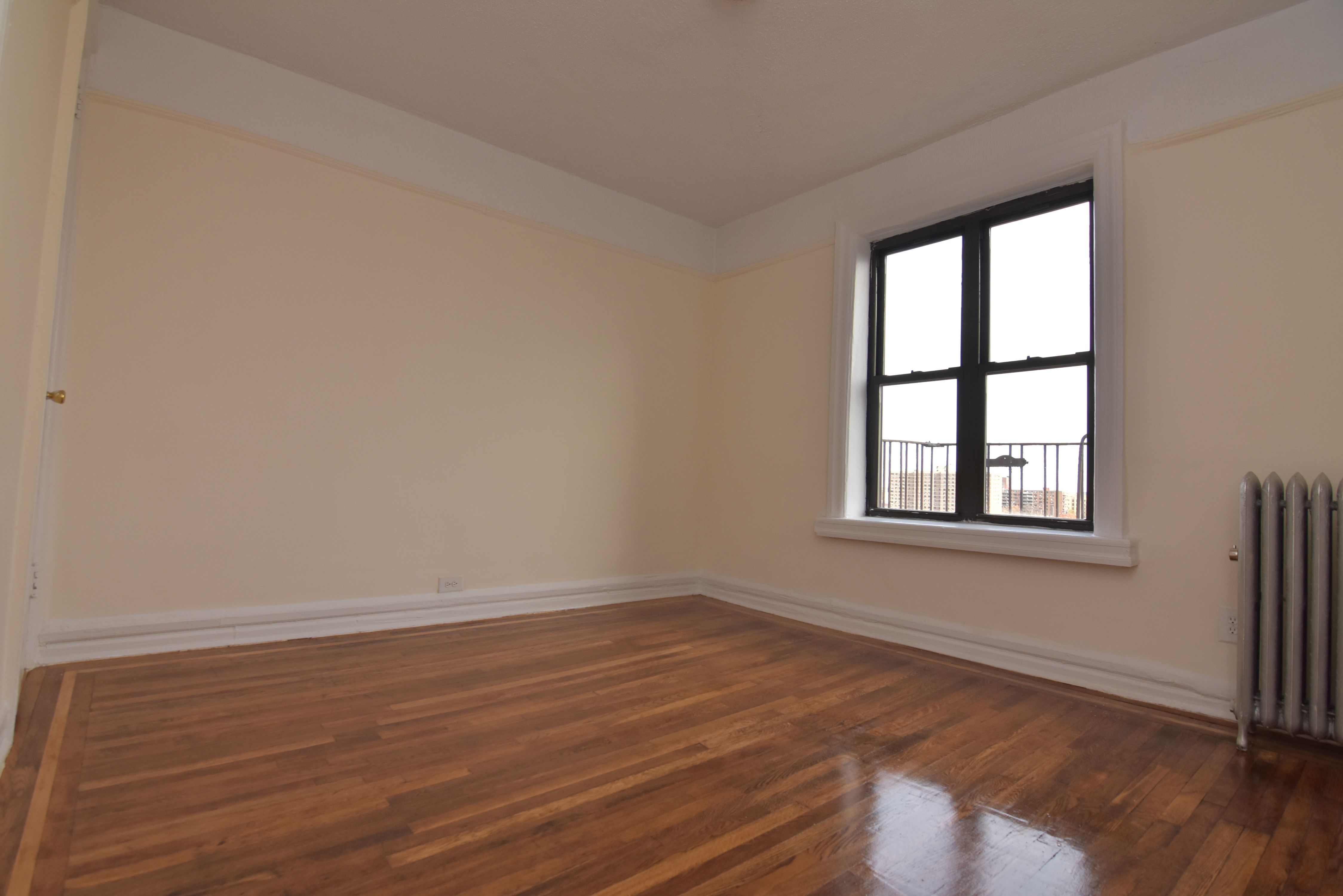 20 Laurel Hill Terrace, Unit 6A Manhattan, NY 10033 - Photo 4 of 11 a view of an empty room with wooden floor and a window