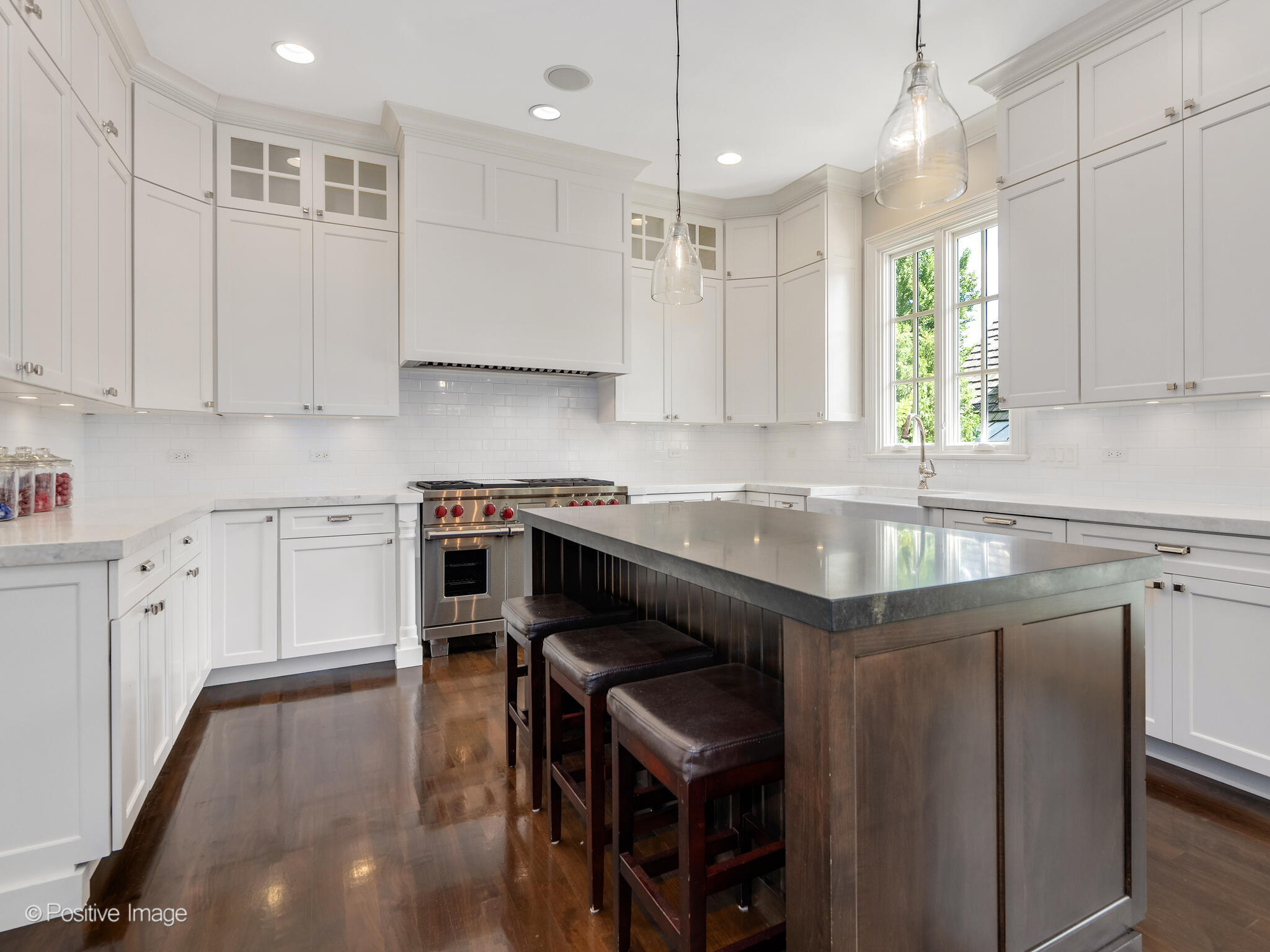 17 South Bruner Street Hinsdale, IL 60521 - Photo 17 of 42 a kitchen with a stove a sink a window and wooden cabinets