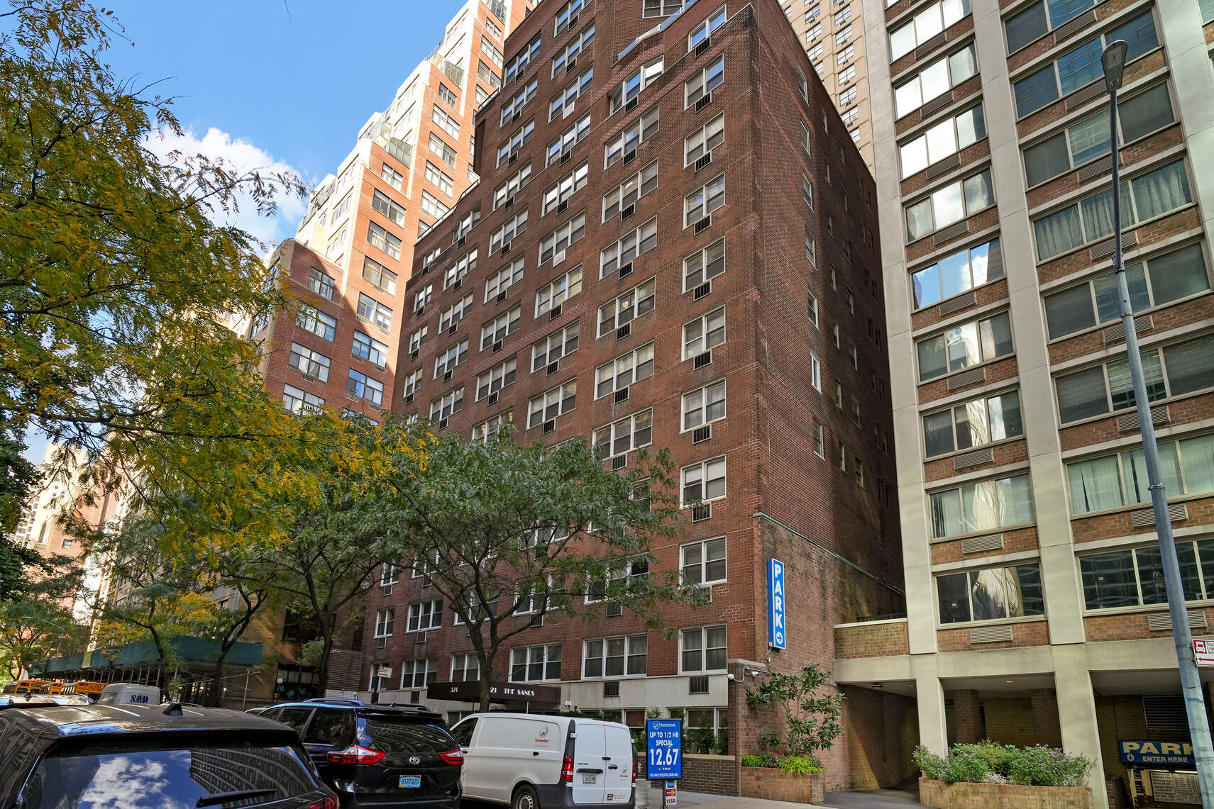 321 East 45th Street, Unit 1F Manhattan, NY 10017 - Photo 9 of 14 a couple of cars parked in front of brick building