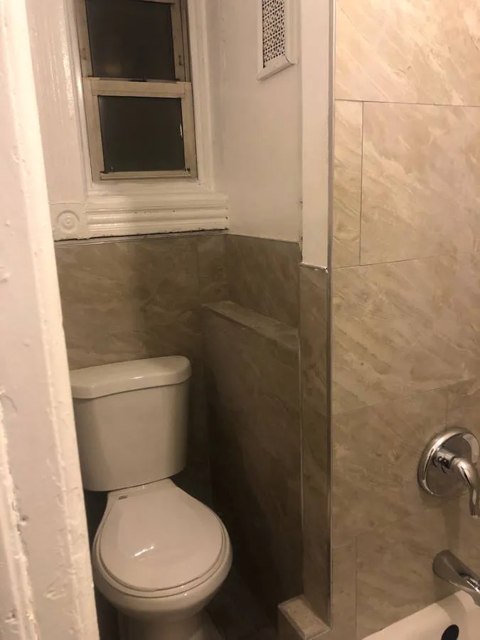 a white toilet sitting next to a bathroom sink
