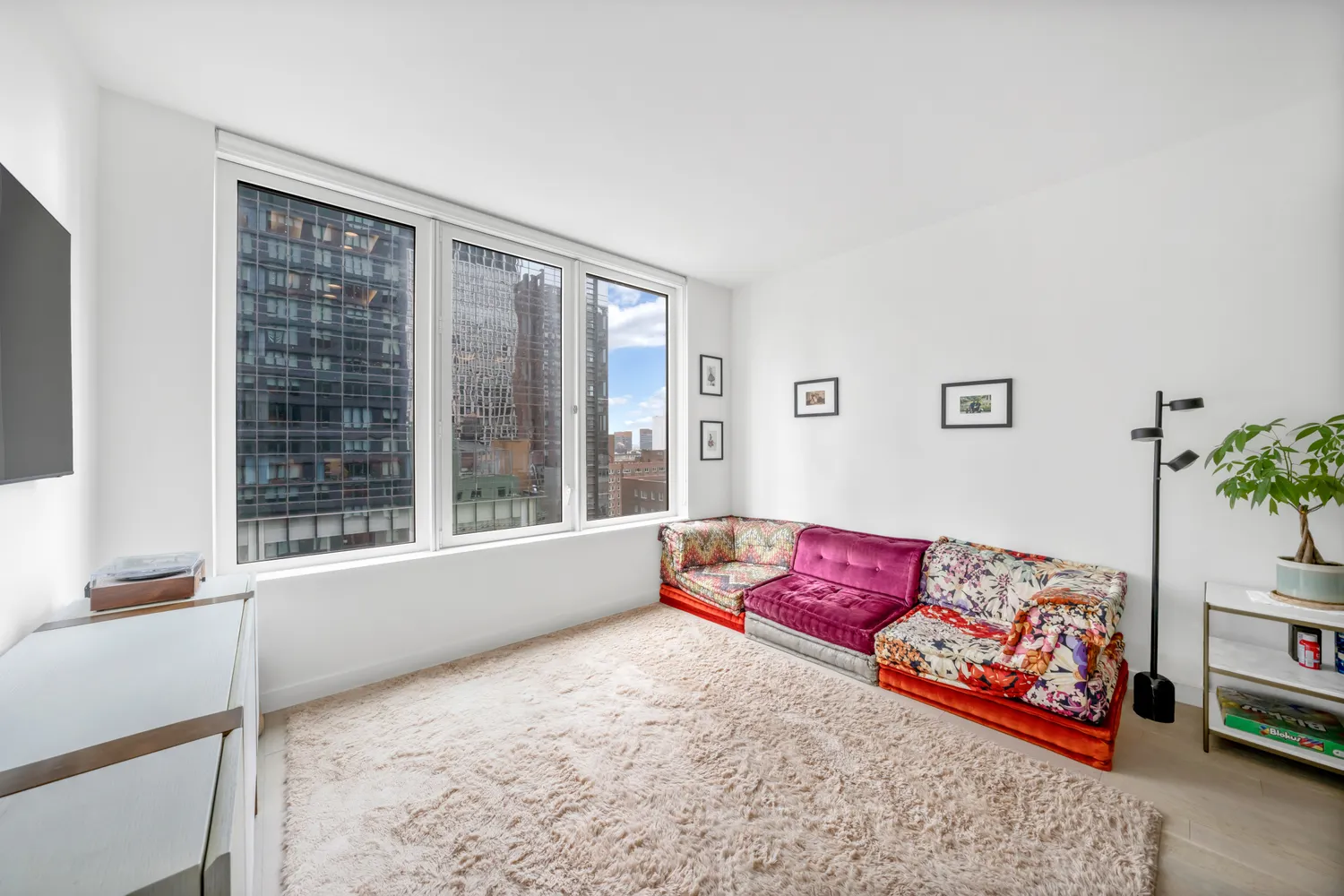 a living room with a large window and a couch