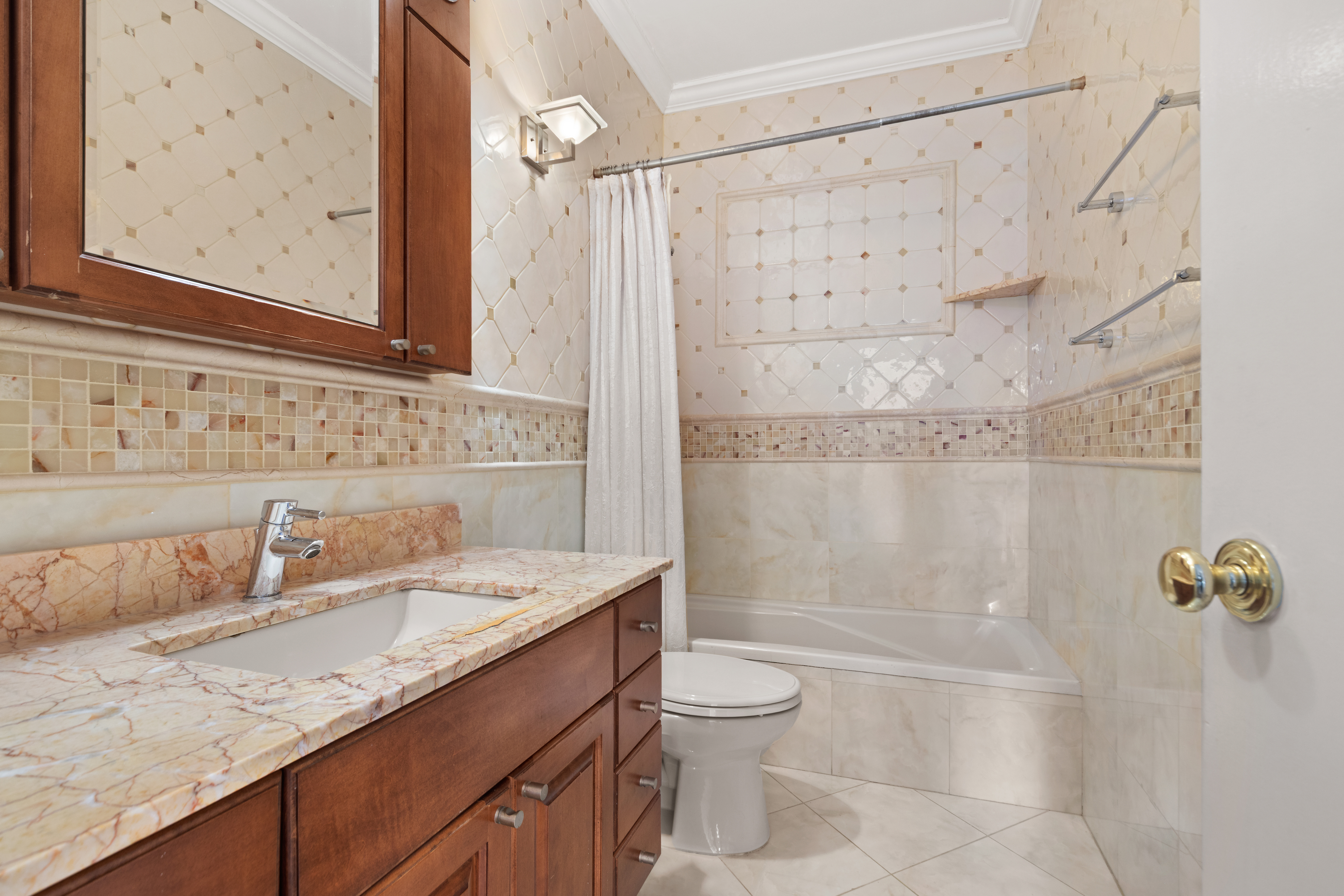 525 East 80th Street, Unit 11A Manhattan, NY 10075 - Photo 8 of 12 a bathroom with a granite countertop sink a toilet and shower