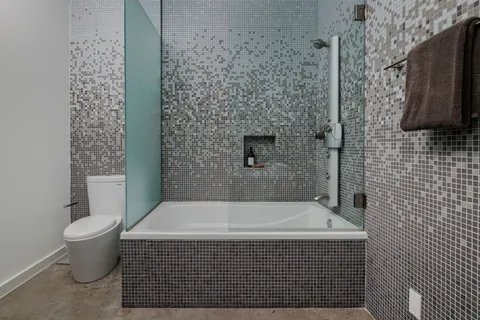 a bathroom with a bathtub and shower