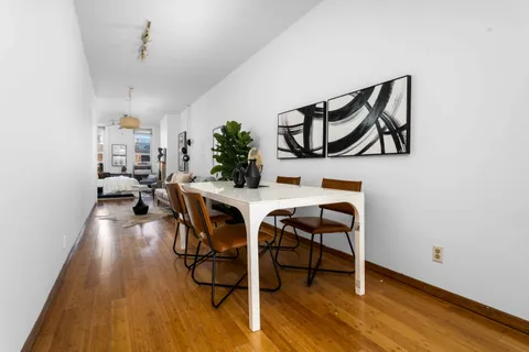 a view of a dining room with furniture and wooden floor