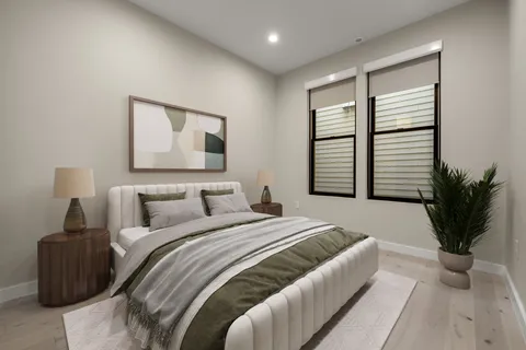 a bedroom with a large bed and a potted plant