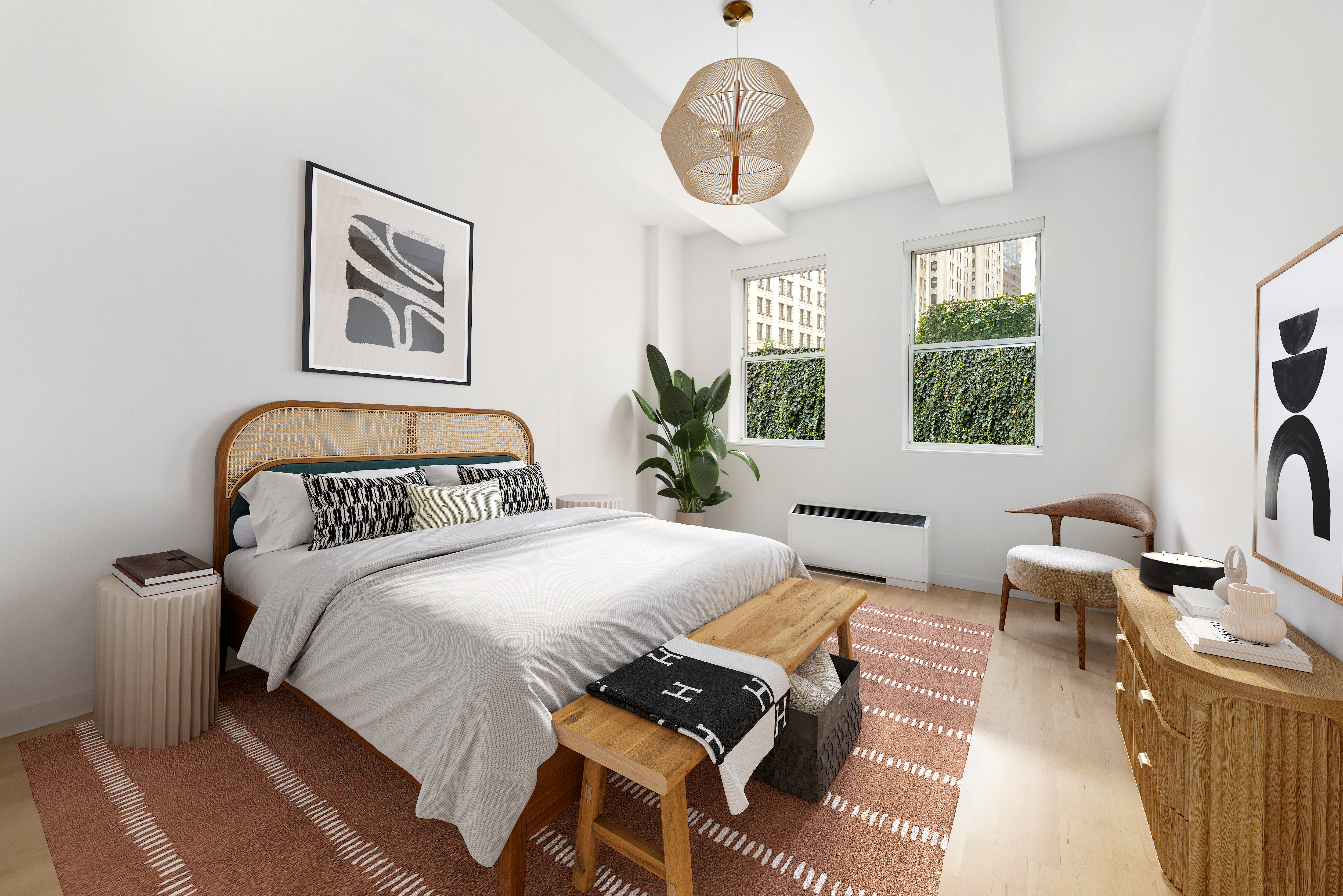 15 Broad Street, Unit 710 Manhattan, NY 10005 - Photo 3 of 11 a bedroom with a large bed and a chandelier