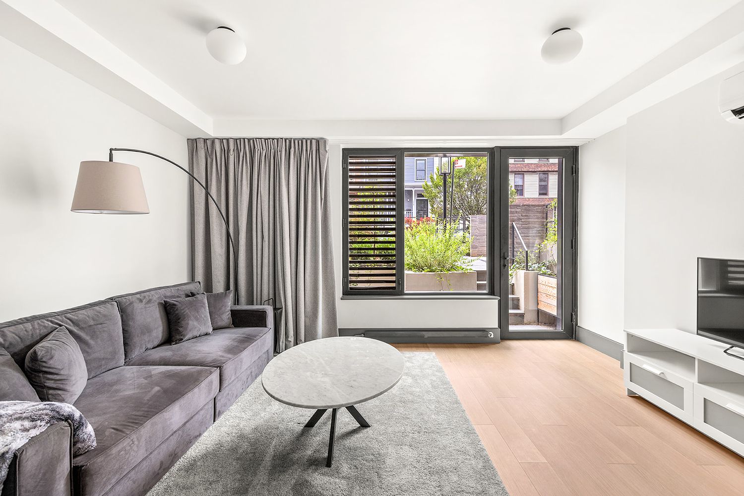 a living room with furniture and a flat screen tv