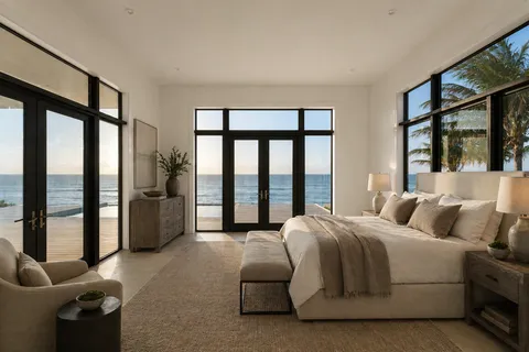 a bedroom with a bed and a large window