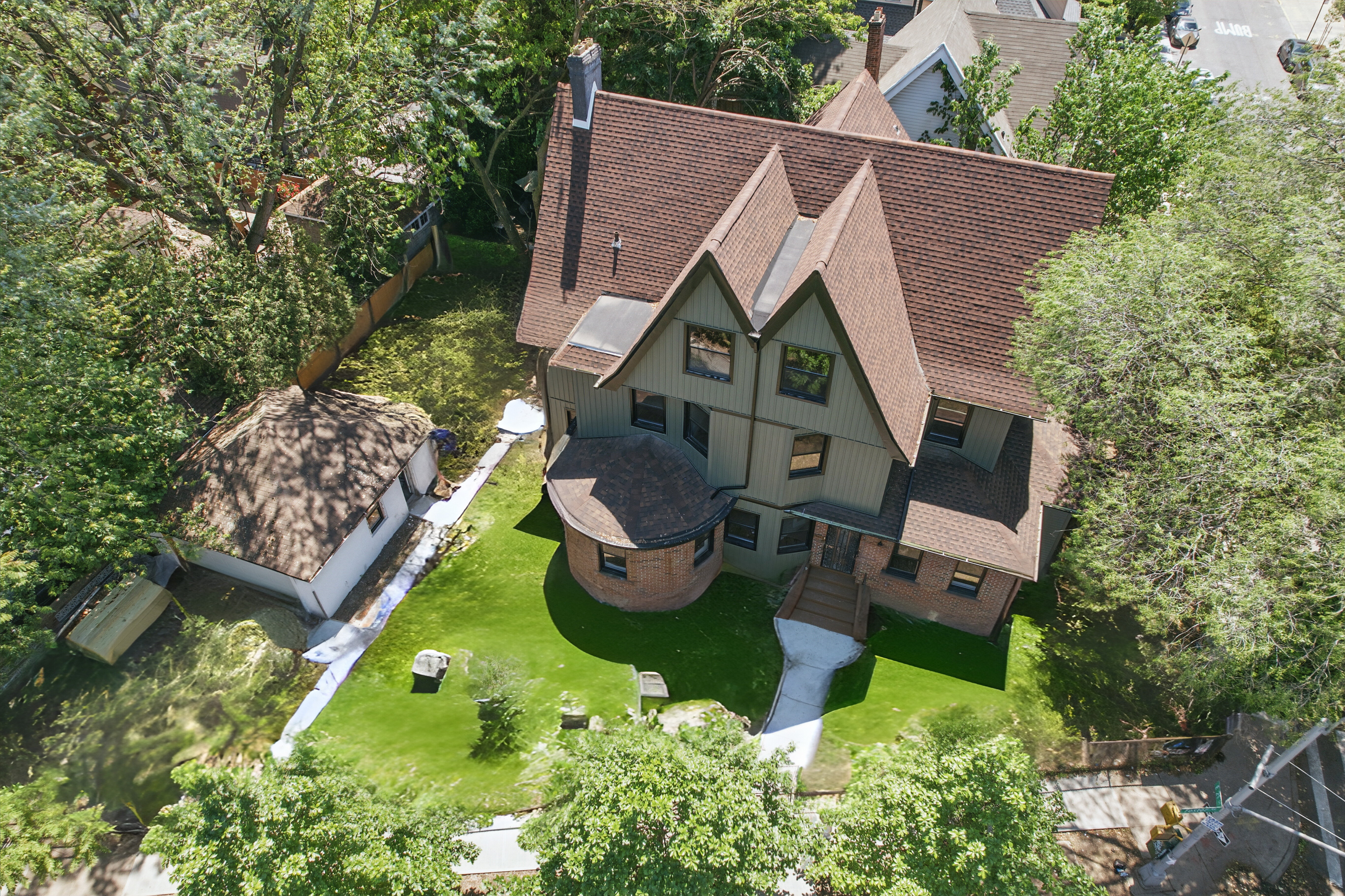 an aerial view of a house with garden space and street view