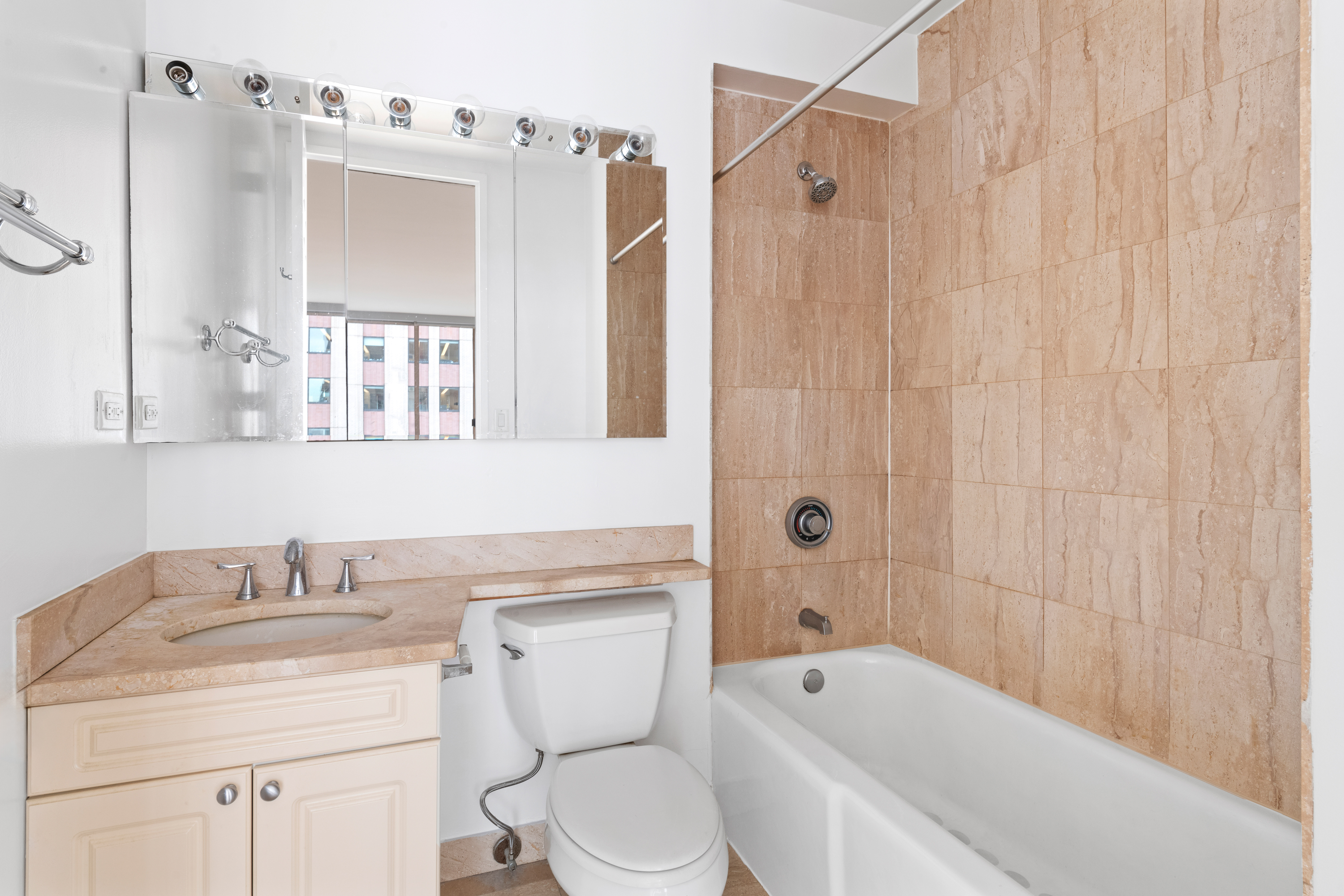 350 West 50th Street, Unit 12B Manhattan, NY 10019 - Photo 9 of 16 a bathroom with a sink a toilet and shower